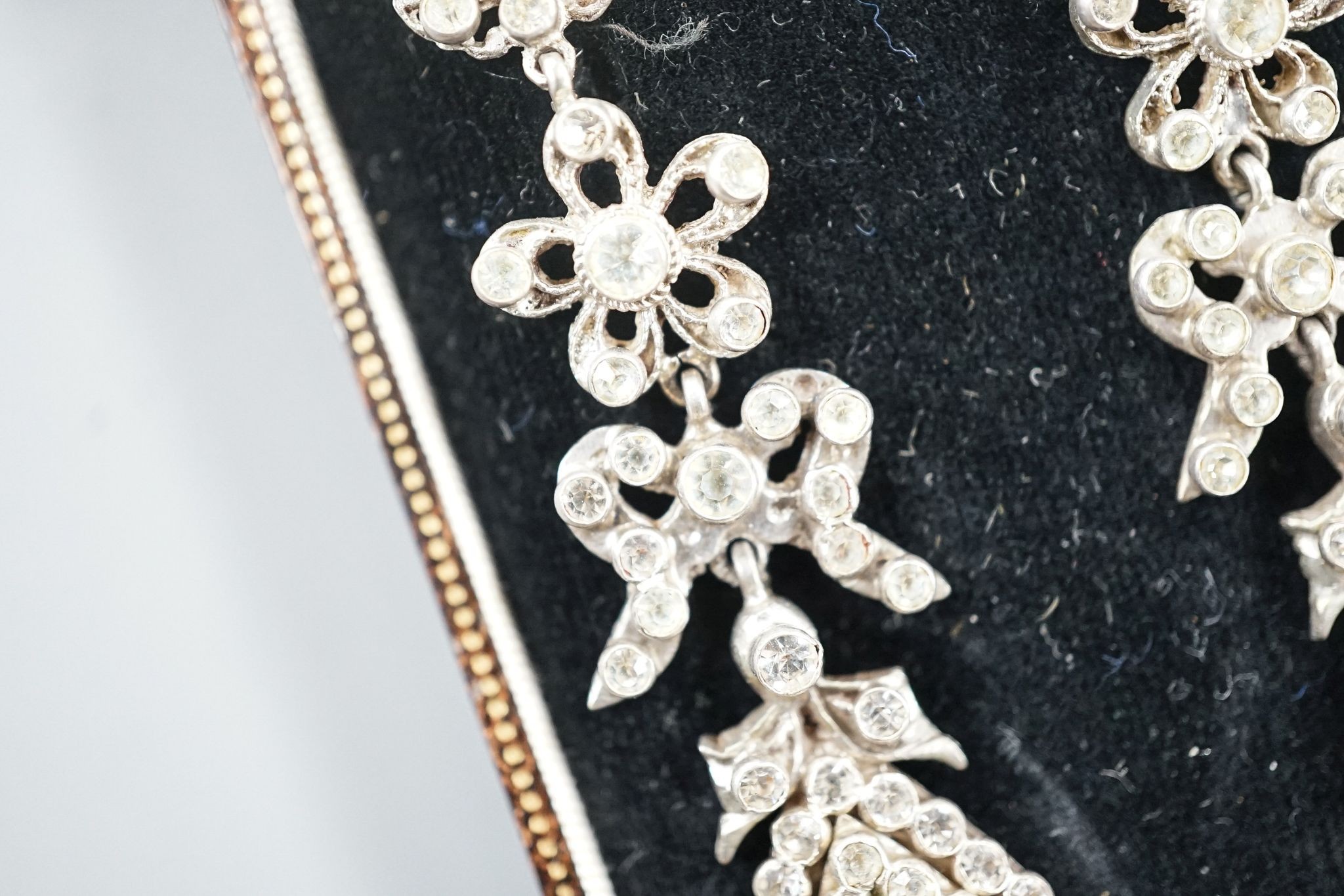 A pair of white metal and two colour paste drop earrings, 68mm, in a gilt tooled leather box.